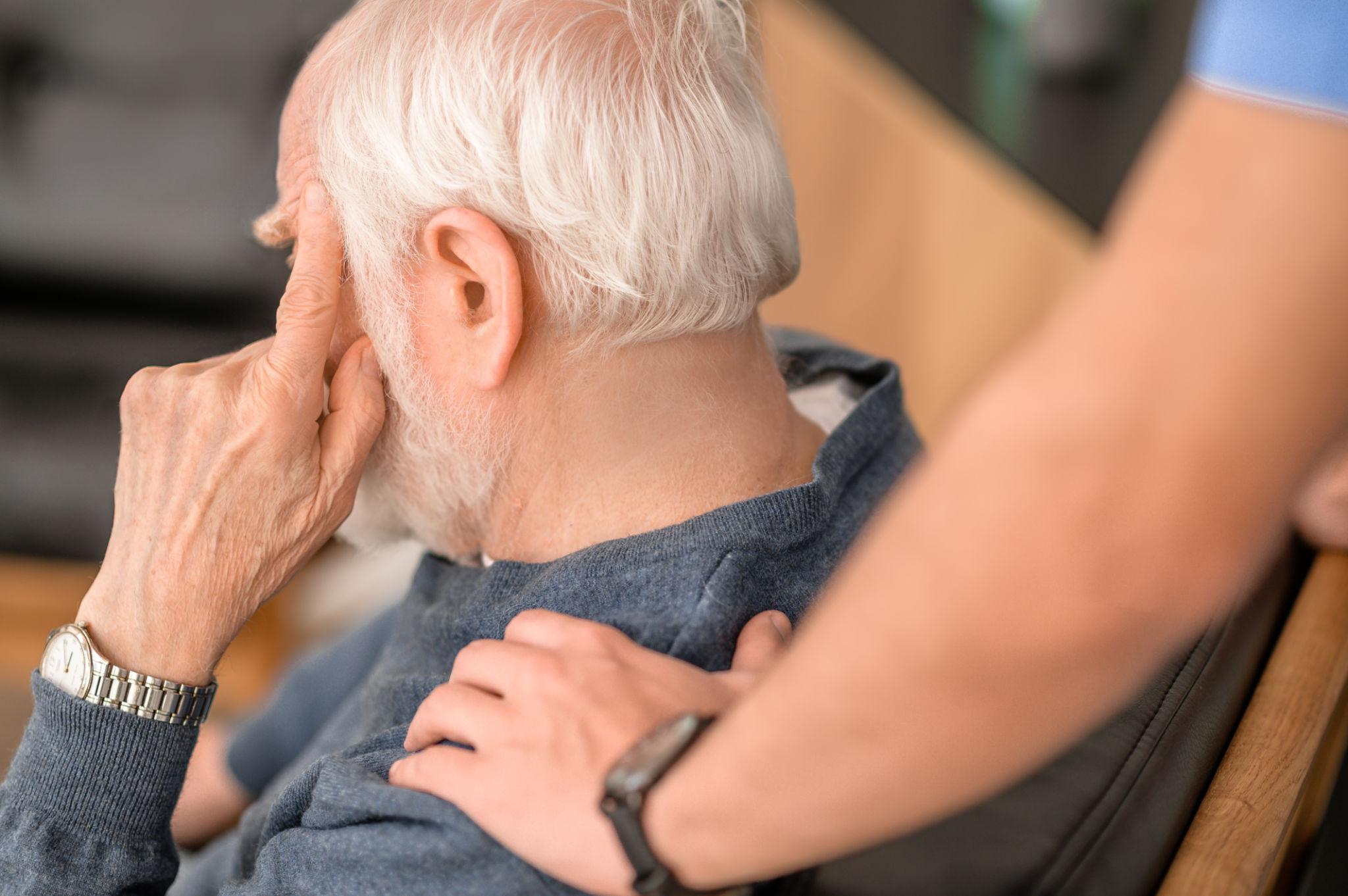 Care staff supporting an older adult in a calm care environment
